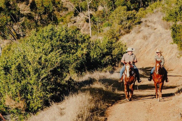 a man riding a bike down a dirt road